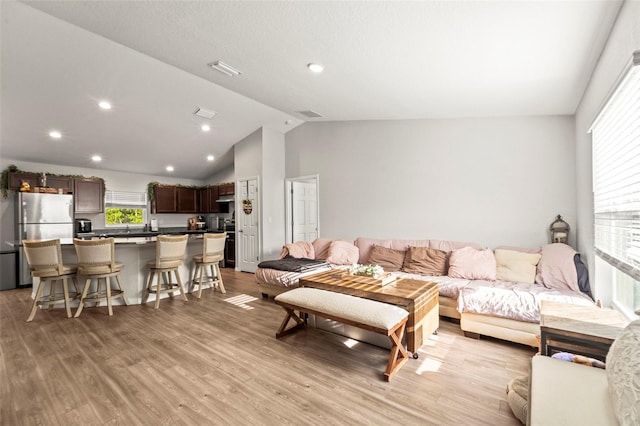 8009 N Primrose Dr, Citrus Springs, FL 34434 - living room with vaulted ceiling, light wood finished floors, and recessed lighting