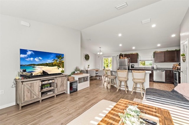 8009 N Primrose Dr, Citrus Springs, FL 34434 - living area with light wood-type flooring, recessed lighting, and lofted ceiling