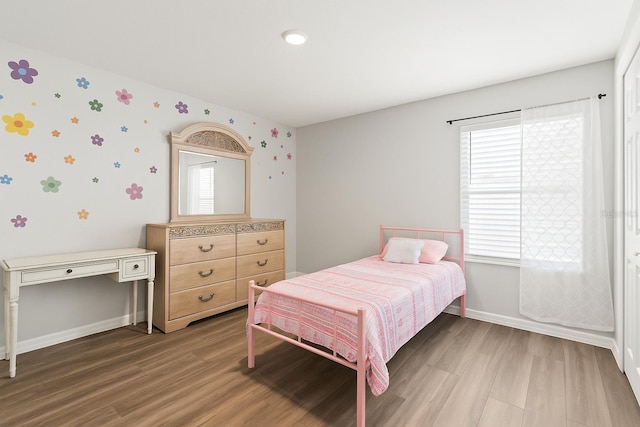 7839 N Quibble Ave, Citrus Springs, FL 34434 - bedroom with wallpapered walls, baseboards, wood finished floors, and multiple windows