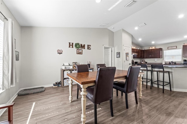 7839 N Quibble Ave, Citrus Springs, FL 34434 - dining area featuring vaulted ceiling, light wood-type flooring, baseboards, and recessed lighting