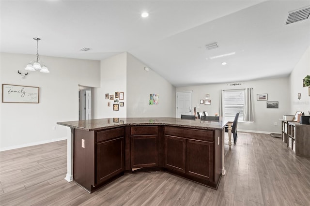 7839 N Quibble Ave, Citrus Springs, FL 34434 - kitchen with light wood-type flooring, a chandelier, dark brown cabinetry, lofted ceiling, and recessed lighting