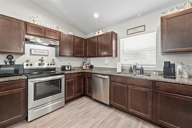 7839 N Quibble Ave, Citrus Springs, FL 34434 - kitchen featuring stainless steel appliances, under cabinet range hood, a sink, and dark stone countertops