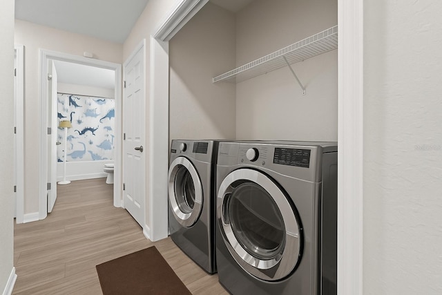 7839 N Quibble Ave, Citrus Springs, FL 34434 - laundry room featuring separate washer and dryer, baseboards, and light wood-style floors