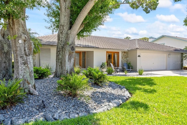 2900 Sandpiper Pl, Clearwater, FL 33762 - ranch-style home with an attached garage, stucco siding, a front lawn, driveway, and a tile roof