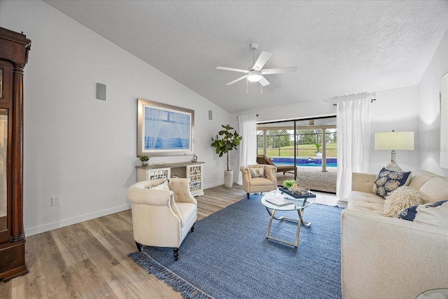 2900 Sandpiper Pl, Clearwater, FL 33762 - living room featuring a ceiling fan, wood finished floors, vaulted ceiling, and baseboards