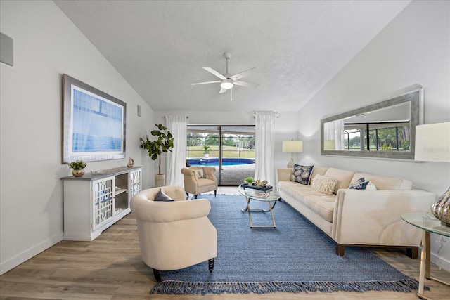 2900 Sandpiper Pl, Clearwater, FL 33762 - living area featuring lofted ceiling, a ceiling fan, wood finished floors, baseboards, and a textured ceiling