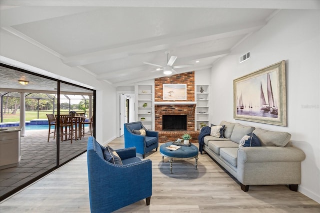 2900 Sandpiper Pl, Clearwater, FL 33762 - living room with ceiling fan, built in features, baseboards, and light wood-style floors