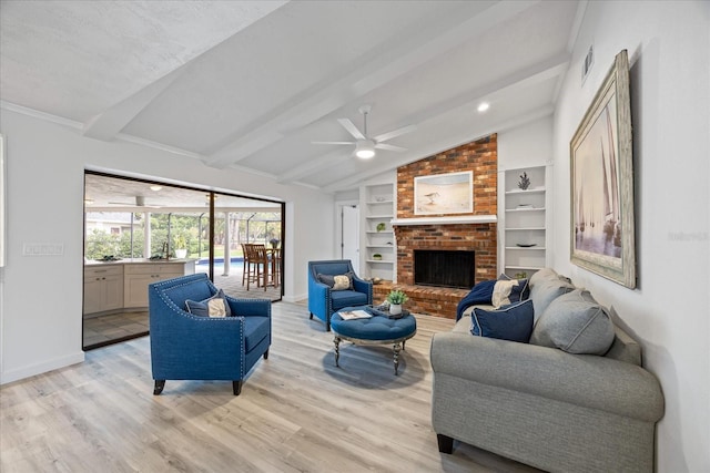 2900 Sandpiper Pl, Clearwater, FL 33762 - living area featuring a ceiling fan, light wood finished floors, a brick fireplace, baseboards, and built in shelves