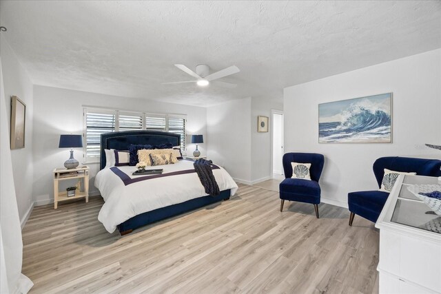 2900 Sandpiper Pl, Clearwater, FL 33762 - bedroom featuring light wood-style flooring, baseboards, a textured ceiling, and ceiling fan