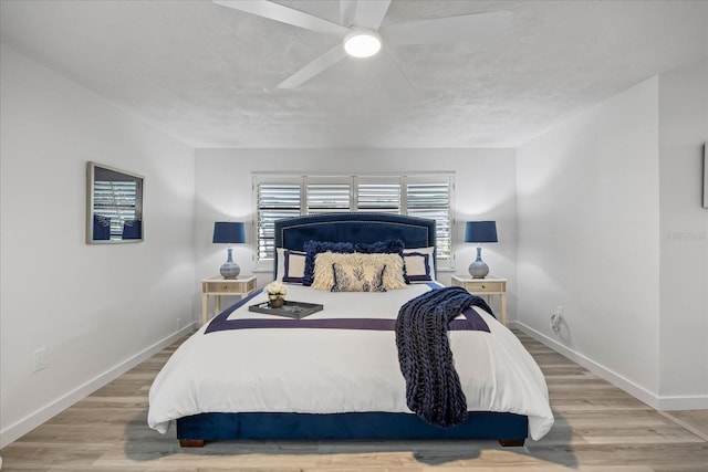 2900 Sandpiper Pl, Clearwater, FL 33762 - bedroom with baseboards, wood finished floors, and a ceiling fan