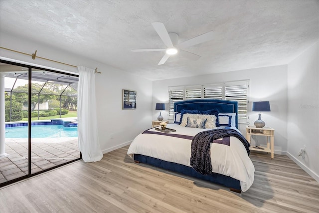 2900 Sandpiper Pl, Clearwater, FL 33762 - bedroom with access to outside, wood finished floors, baseboards, a textured ceiling, and ceiling fan