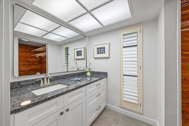 2900 Sandpiper Pl, Clearwater, FL 33762 - bathroom featuring vanity, tile patterned floors, baseboards, and a closet