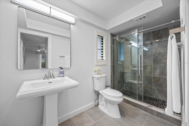 2900 Sandpiper Pl, Clearwater, FL 33762 - bathroom with toilet, a stall shower, baseboards, and tile patterned floors