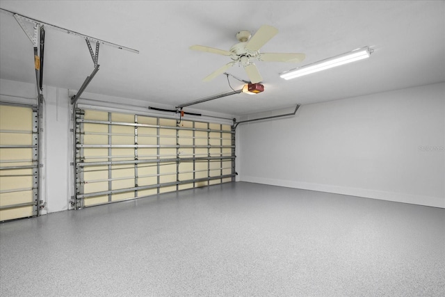 2900 Sandpiper Pl, Clearwater, FL 33762 - garage featuring a garage door opener, baseboards, and ceiling fan