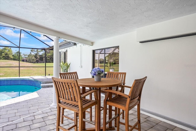 2900 Sandpiper Pl, Clearwater, FL 33762 - dining space featuring a sunroom, a textured ceiling, and baseboards