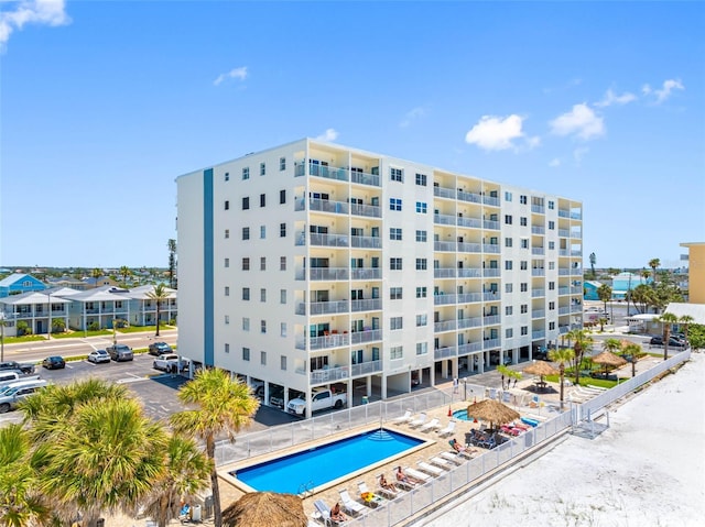 13500 Gulf Blvd Unit 506, Madeira Beach, FL 33708 - view of apartment building / complex featuring uncovered parking and a community pool