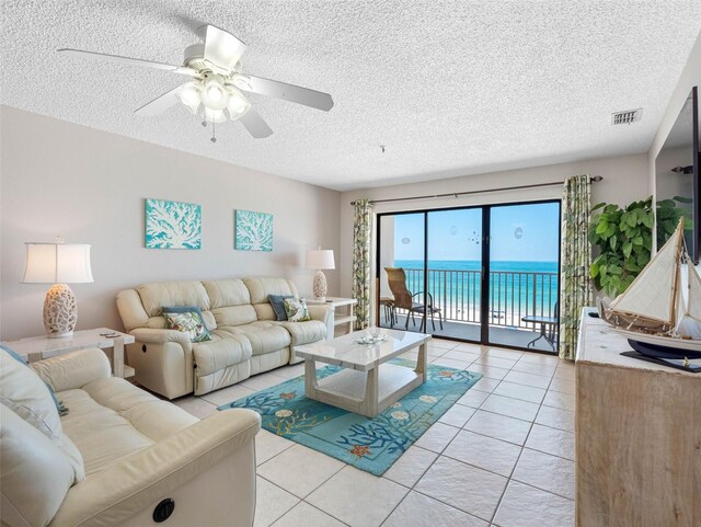 13500 Gulf Blvd Unit 506, Madeira Beach, FL 33708 - living area with a textured ceiling, light tile patterned floors, and ceiling fan
