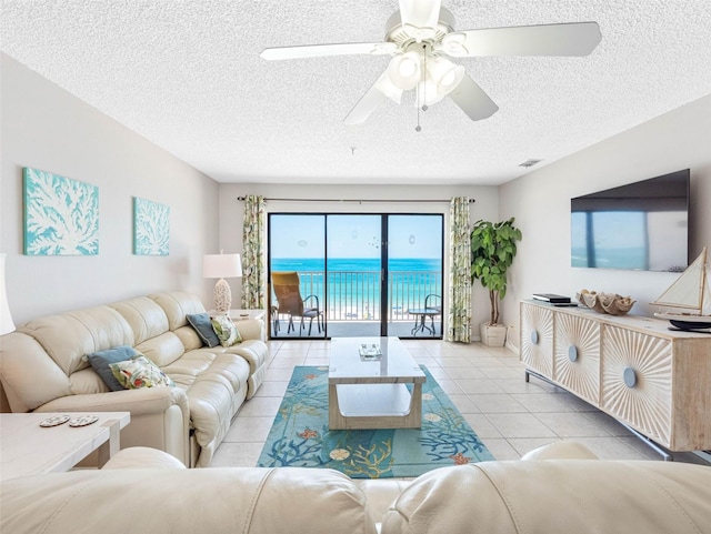 13500 Gulf Blvd Unit 506, Madeira Beach, FL 33708 - tiled living room featuring a textured ceiling and ceiling fan