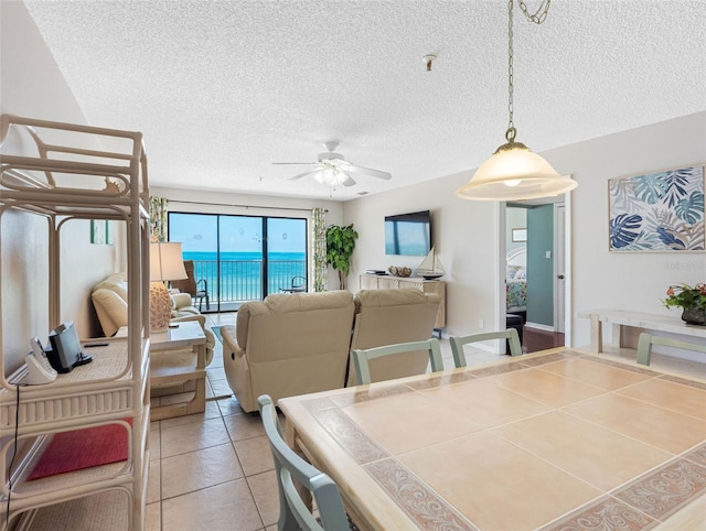 13500 Gulf Blvd Unit 506, Madeira Beach, FL 33708 - dining space with ceiling fan, tile patterned flooring, and a textured ceiling