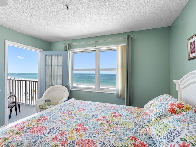 13500 Gulf Blvd Unit 506, Madeira Beach, FL 33708 - bedroom featuring a water view and a textured ceiling