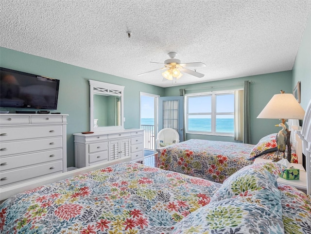 13500 Gulf Blvd Unit 506, Madeira Beach, FL 33708 - bedroom featuring a textured ceiling, ceiling fan, and access to exterior
