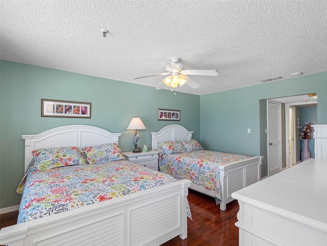 13500 Gulf Blvd Unit 506, Madeira Beach, FL 33708 - bedroom with dark wood-style floors, ceiling fan, and a textured ceiling