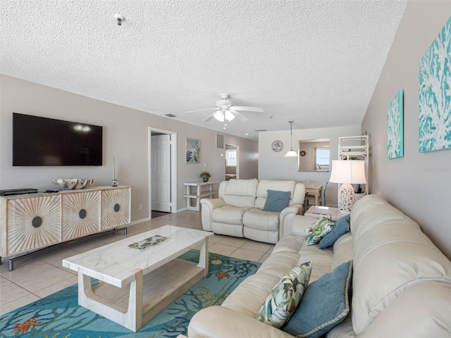 13500 Gulf Blvd Unit 506, Madeira Beach, FL 33708 - living room featuring tile patterned floors, ceiling fan, and a textured ceiling