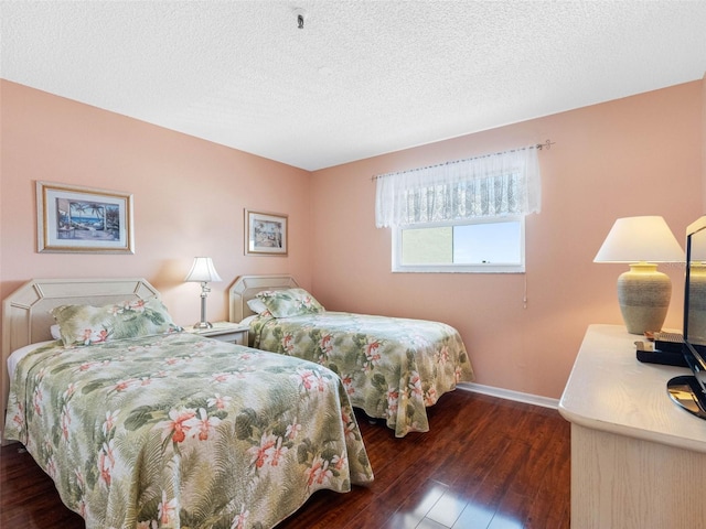 13500 Gulf Blvd Unit 506, Madeira Beach, FL 33708 - bedroom with wood-type flooring, baseboards, and a textured ceiling