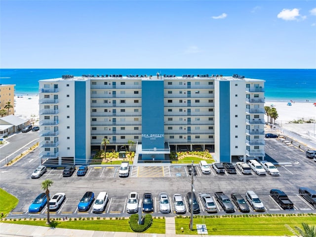 13500 Gulf Blvd Unit 506, Madeira Beach, FL 33708 - view of apartment building / complex featuring uncovered parking and a water view