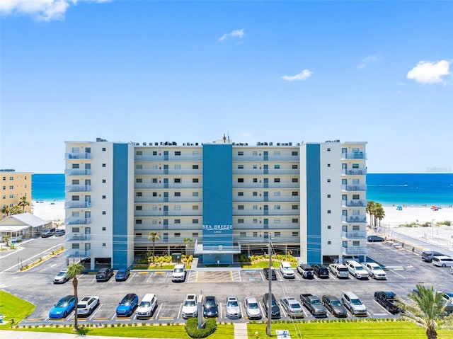 13500 Gulf Blvd Unit 506, Madeira Beach, FL 33708 - view of property featuring uncovered parking and view of water and beach
