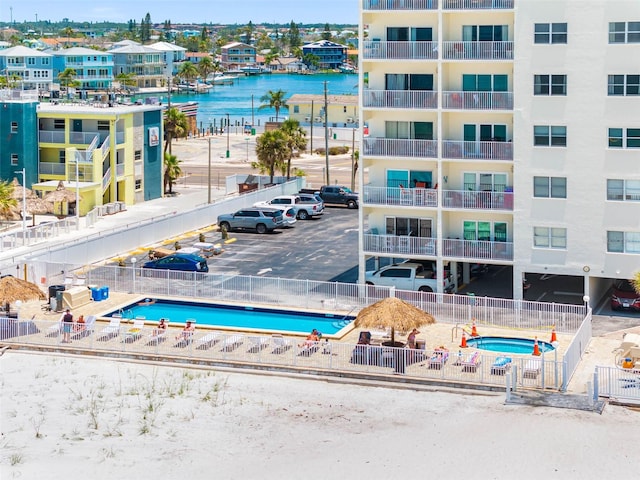 13500 Gulf Blvd Unit 506, Madeira Beach, FL 33708 - drone / aerial view of a pool area, apartment complex, and a nearby body of water