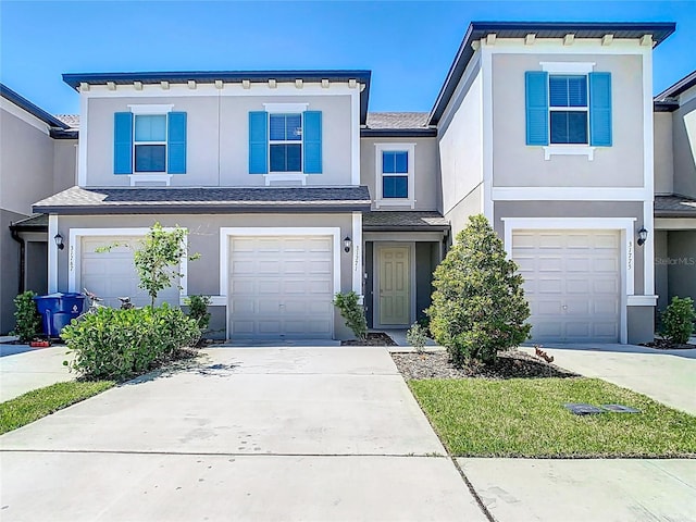 31771 Blue Passing Loop, Wesley Chapel, FL 33545 - view of front facade featuring an attached garage, stucco siding, driveway, and roof with shingles