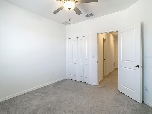31771 Blue Passing Loop, Wesley Chapel, FL 33545 - unfurnished bedroom featuring light colored carpet, a closet, baseboards, and ceiling fan