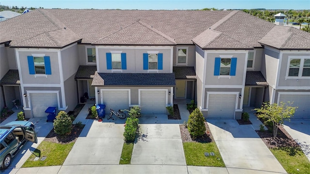 31771 Blue Passing Loop, Wesley Chapel, FL 33545 - view of property featuring driveway, a garage, and stucco siding