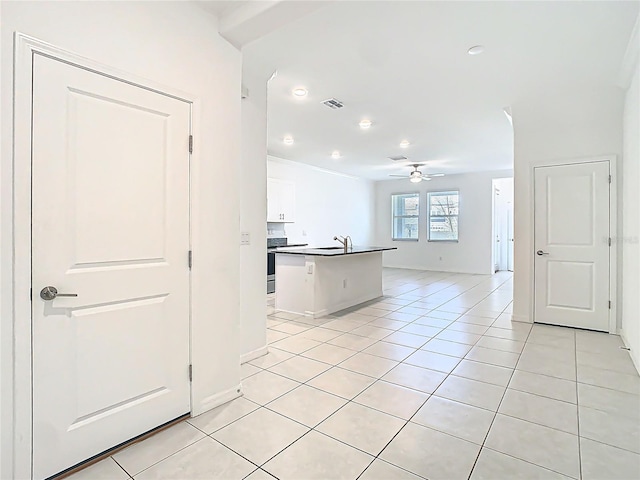 31771 Blue Passing Loop, Wesley Chapel, FL 33545 - kitchen featuring a ceiling fan, dark countertops, light tile patterned flooring, open floor plan, and white cabinets