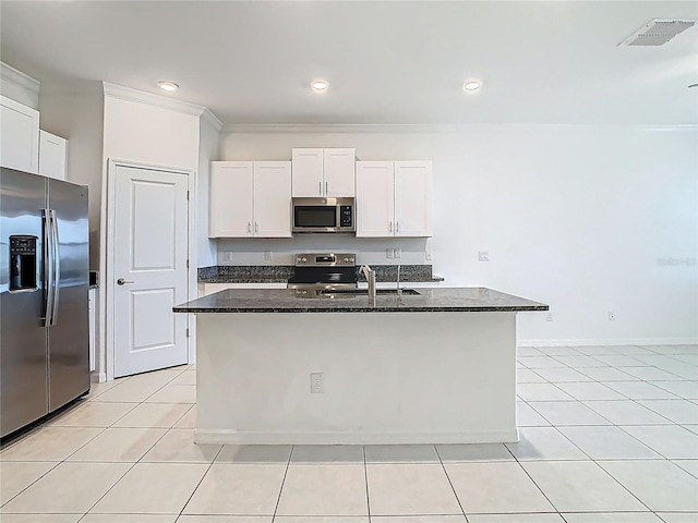31771 Blue Passing Loop, Wesley Chapel, FL 33545 - kitchen featuring appliances with stainless steel finishes, dark stone countertops, light tile patterned floors, white cabinets, and crown molding