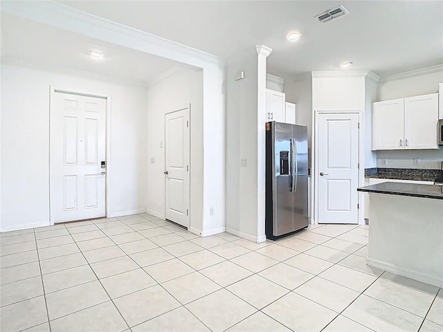 31771 Blue Passing Loop, Wesley Chapel, FL 33545 - kitchen with stainless steel appliances, dark countertops, crown molding, white cabinets, and light tile patterned flooring