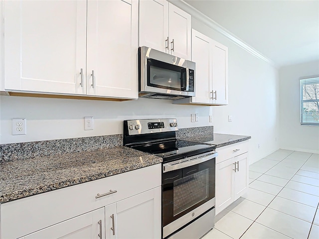 31771 Blue Passing Loop, Wesley Chapel, FL 33545 - kitchen with appliances with stainless steel finishes, white cabinets, crown molding, dark stone counters, and light tile patterned floors