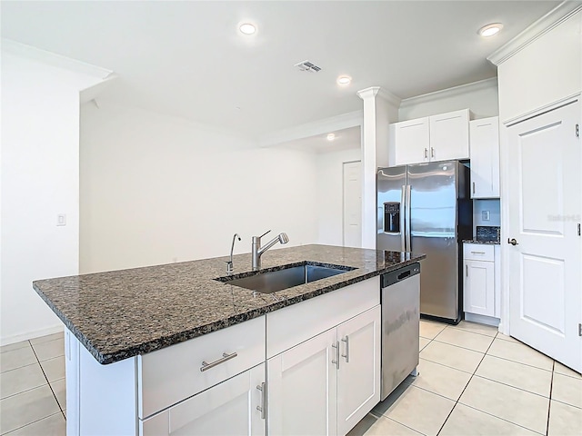 31771 Blue Passing Loop, Wesley Chapel, FL 33545 - kitchen featuring a sink, stainless steel appliances, light tile patterned floors, an island with sink, and dark stone counters
