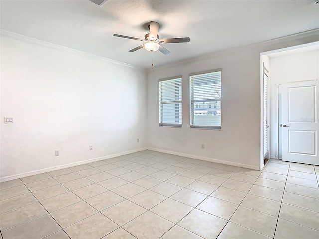 31771 Blue Passing Loop, Wesley Chapel, FL 33545 - empty room featuring light tile patterned flooring, ceiling fan, crown molding, and baseboards
