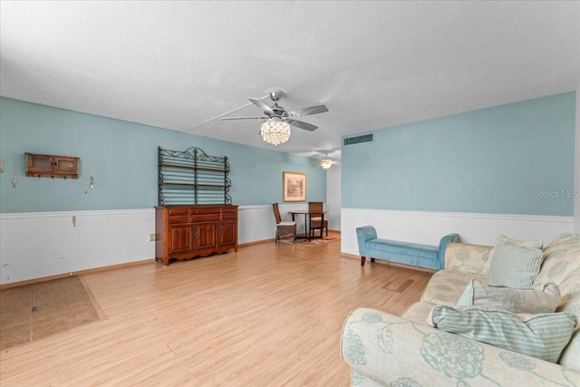 2630 Pearce Dr Unit 108, Clearwater, FL 33764 - living room featuring wood finished floors, a ceiling fan, and a textured ceiling