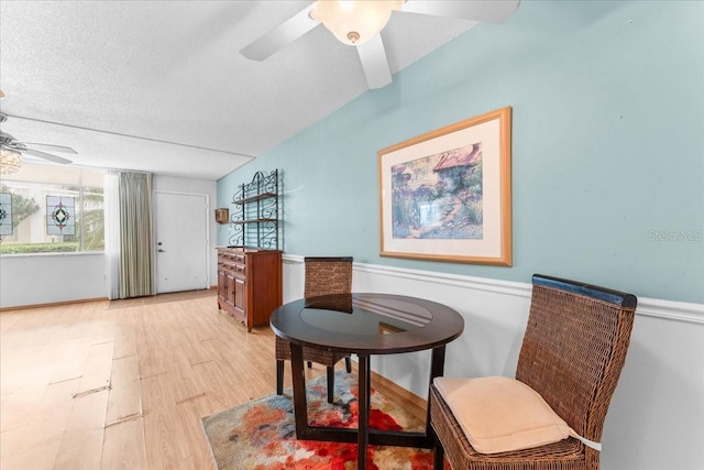 2630 Pearce Dr Unit 108, Clearwater, FL 33764 - sitting room with a ceiling fan, wainscoting, a textured ceiling, and light wood-style floors