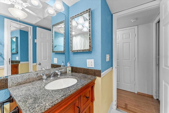 2630 Pearce Dr Unit 108, Clearwater, FL 33764 - full bathroom featuring vanity, wood finished floors, and a textured wall