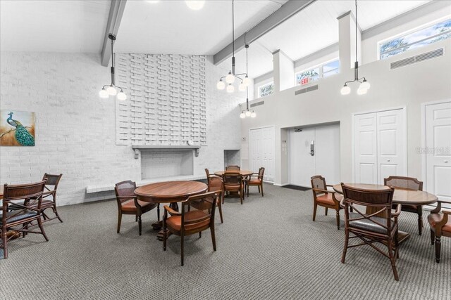 2630 Pearce Dr Unit 108, Clearwater, FL 33764 - carpeted dining room with a high ceiling, healthy amount of natural light, beamed ceiling, and a fireplace