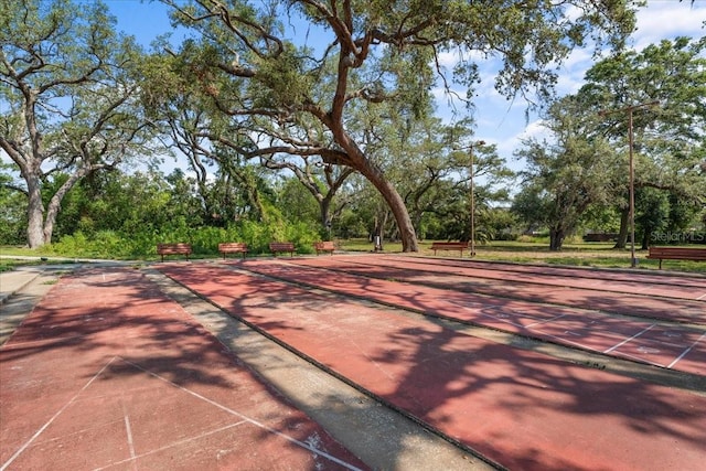 2630 Pearce Dr Unit 108, Clearwater, FL 33764 - view of tennis court featuring shuffleboard and view of wooded area