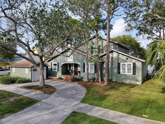761 Bay Esplanade, Clearwater Beach, FL 33767 - bungalow-style house featuring concrete driveway, a front lawn, a garage, and covered porch