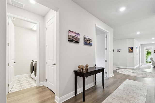 527 Bay St, Dunedin, FL 34698 - corridor featuring separate washer and dryer, wood finished floors, recessed lighting, and baseboards