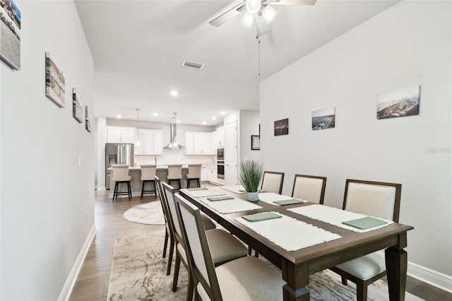 527 Bay St, Dunedin, FL 34698 - dining space featuring light wood-style flooring, baseboards, recessed lighting, and a ceiling fan