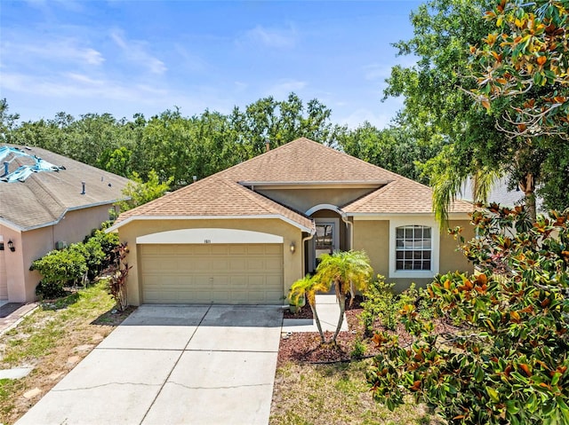 1611 Cresson Ridge Ln, Brandon, FL 33510 - view of front of house with stucco siding, an attached garage, driveway, and a shingled roof