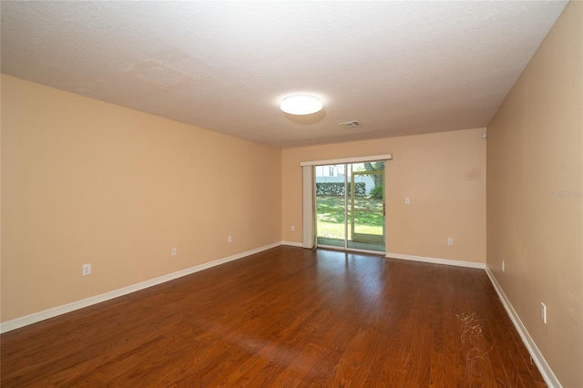 37712 Aaralyn Rd, Zephyrhills, FL 33542 - unfurnished room featuring dark wood-style floors and baseboards